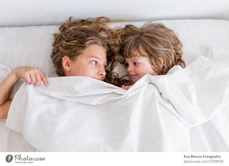 two young beautiful kids resting on bed Lifestyle Joy Beautiful Relaxation Leisure and hobbies Playing House (Residential Structure) Bed Child Schoolchild