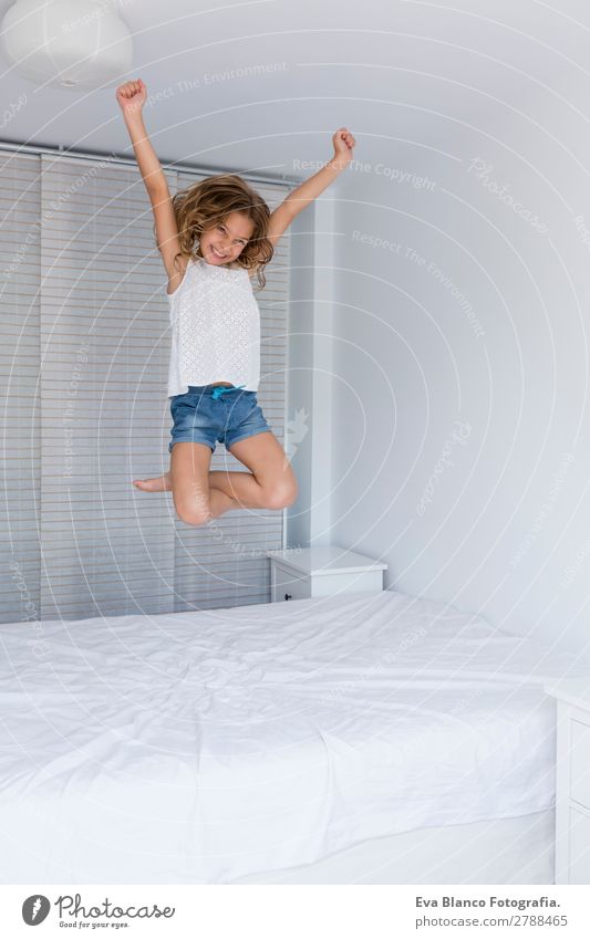 beautiful kid girl jumping on bed Lifestyle Joy Beautiful Leisure and hobbies Playing Summer House (Residential Structure) Bed Room Bedroom Child Schoolchild