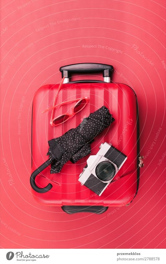 Red travel suitcase, sunglasses, old camera, black umbrella Relaxation Vacation & Travel Trip Summer Camera Transport Sunglasses Plastic Old To fall bag
