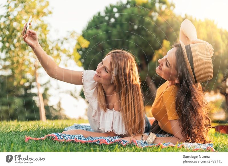 Beautiful women taking a selfie portrait in park. Woman Picnic Friendship Youth (Young adults) Park Happy Summer Human being Joy Mobile PDA Telephone Solar cell