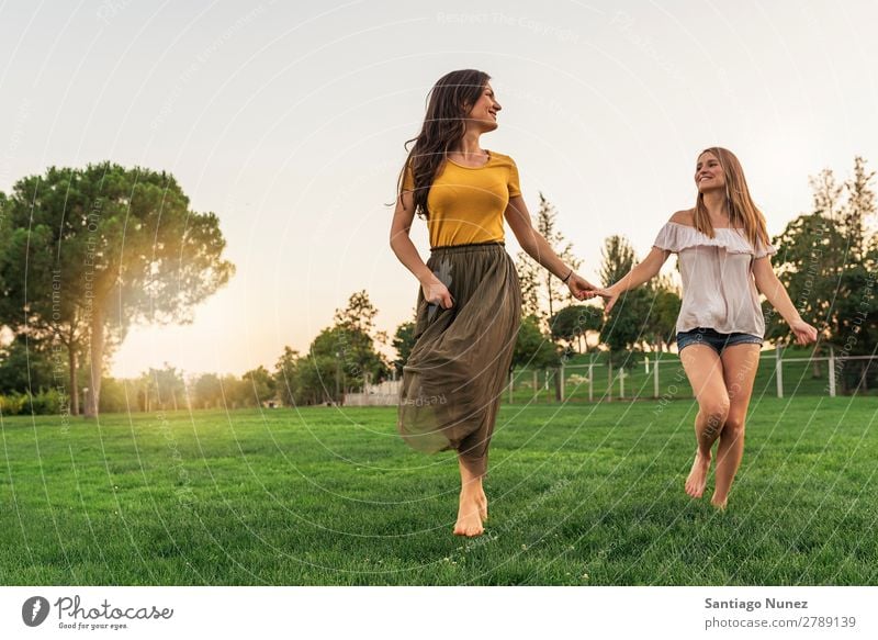 Beautiful women smiling and having fun and running. Woman Picnic Friendship Youth (Young adults) Running Hand Playing Park Happy Summer Human being Joy Adults