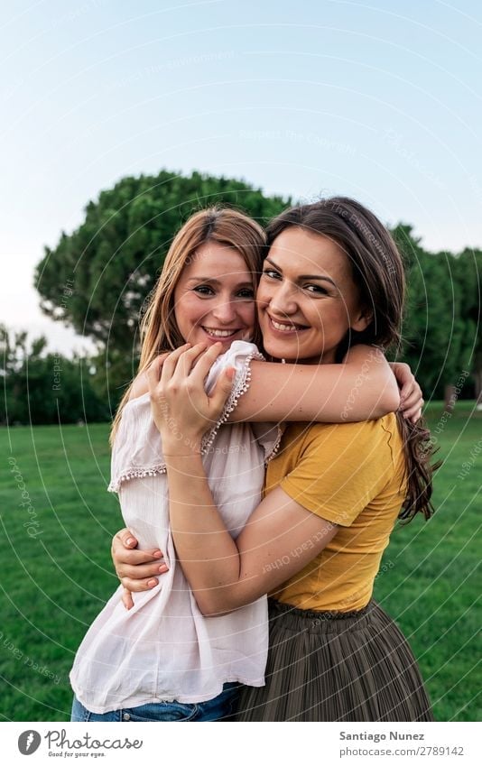 Beautiful women smiling and having fun. Woman Picnic Friendship Youth (Young adults) Park Happy Embrace Summer Human being Joy Playing Adults Girl pretty