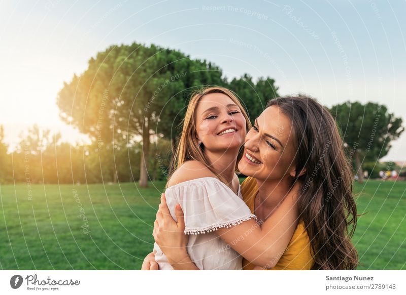 Beautiful women smiling and having fun in the park. Woman Picnic Friendship Youth (Young adults) Park Happy Embrace Summer Human being Joy Playing Adults Girl