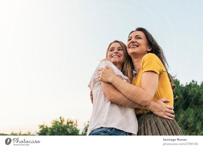 Beautiful women smiling and having fun. Woman Picnic Friendship Youth (Young adults) Park Happy Embrace Summer Human being Joy Playing Adults Girl pretty