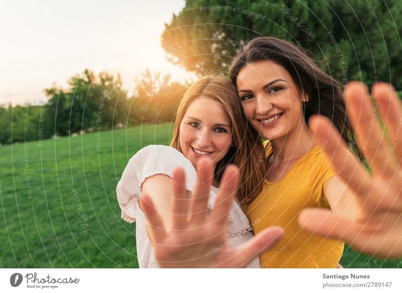 Beautiful women smiling and having fun in the park. Woman Picnic Friendship Youth (Young adults) Park Happy Embrace Hand Summer Human being Joy Playing Adults
