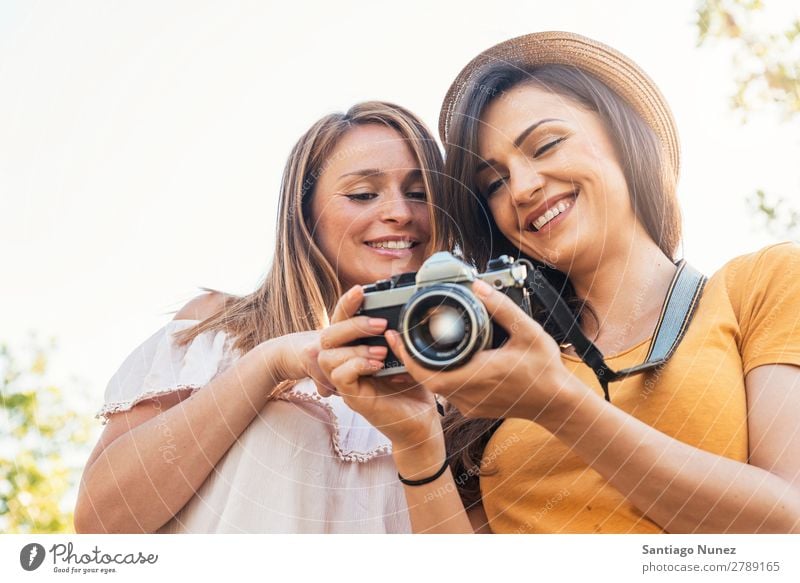 Photographer showing a picture to her friend. Woman Picnic Friendship Youth (Young adults) Park Happy Camera Guitar Guitarist session Photography Indicate