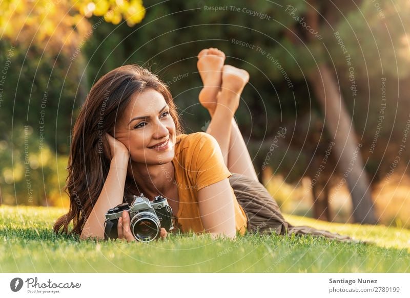 Smiling young woman using a camera to take photo. Photographer Woman Photography Camera Youth (Young adults) Girl Digital White Leisure and hobbies 1 Take