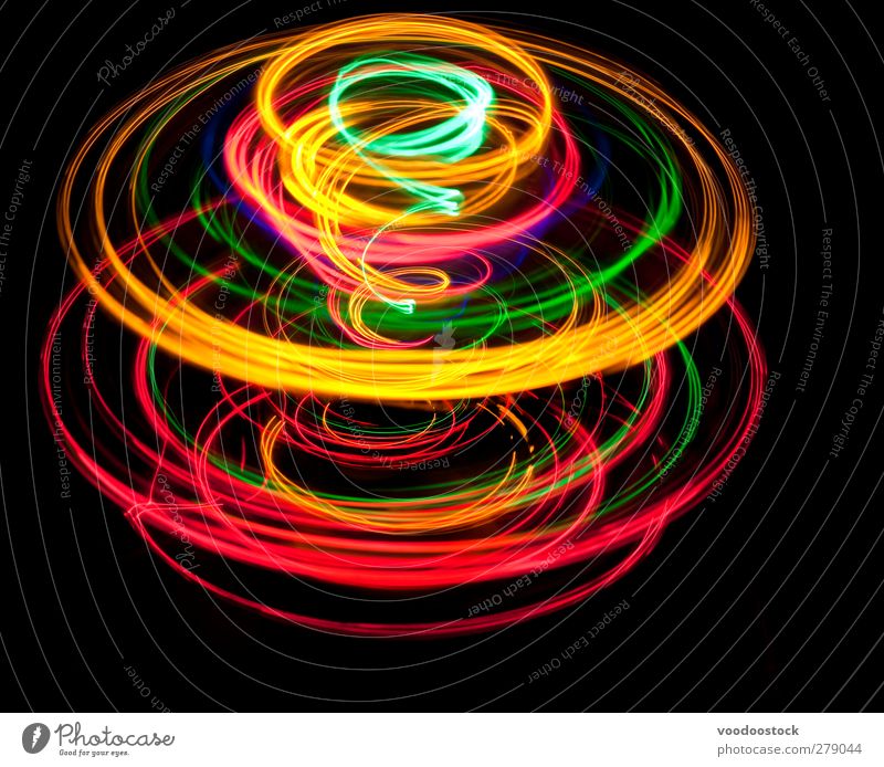 Spinning top of light Spiral Bright Yellow Green Red Black Colour circles trace colorful glowing eye catching Motion blur Rotation Rotate rotating