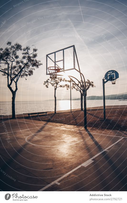 Basketball court on shore of ocean Court building Coast Ocean Sports Water Surface Sky Clouds Sunset Heaven Conceptual design Sunbeam Evening Action Playing