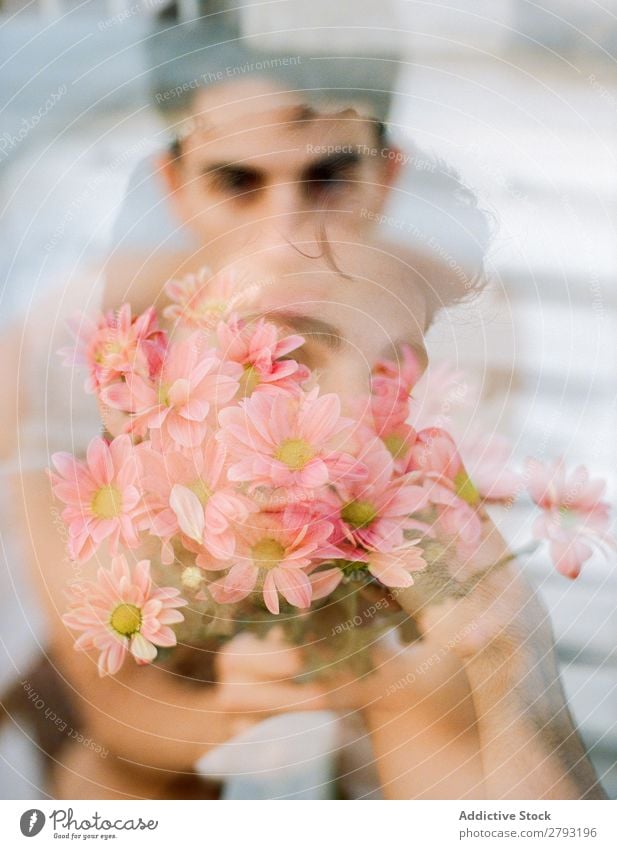 Face of young man with pink flowers Man Flower Bouquet Guy Fresh Youth (Young adults) Brunette Rose Pink Surprise Chrysanthemum through window bunch Gift
