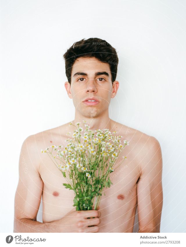 Young man with bunch of flowers in hands Man Mouth Flower Guy Fresh Youth (Young adults) Brunette White shirtless Surprise Gift romantic Daisy