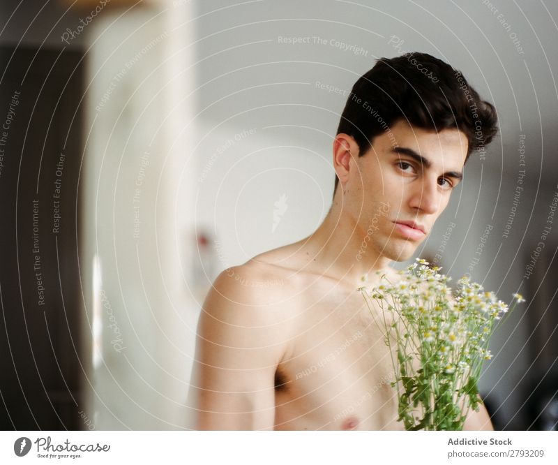Young man with bunch of flowers in hands Man Mouth Flower Guy Fresh Youth (Young adults) Brunette White shirtless Surprise Gift romantic Daisy