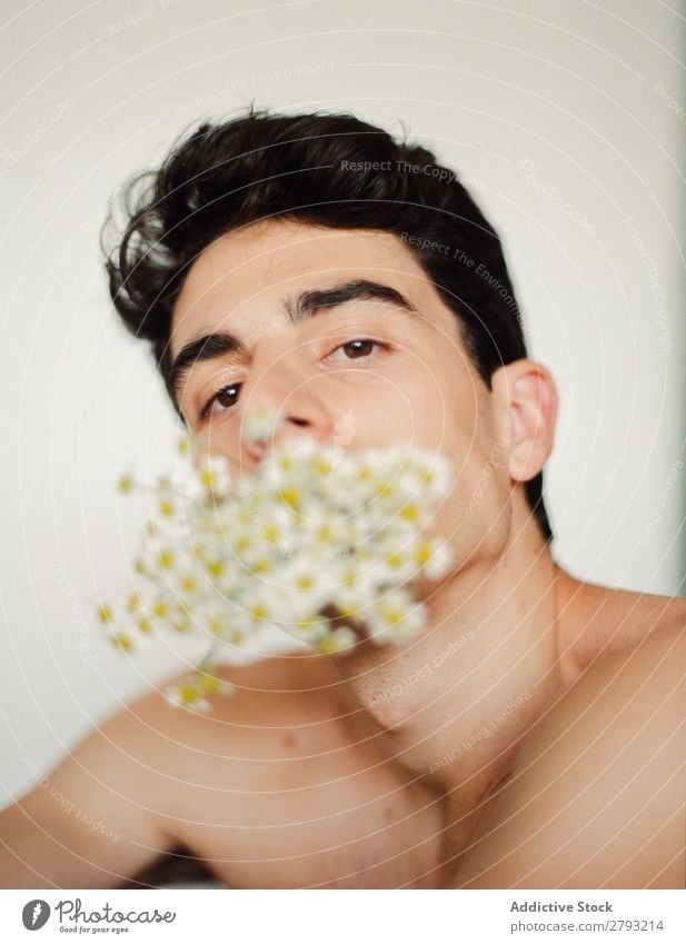 Young man with bunch of flowers in mouth Man Mouth Flower Guy Fresh Youth (Young adults) Brunette White shirtless Surprise Gift romantic Daisy