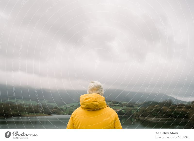Person in coat with camera near lake Human being Camera Lake Coat Picturesque Hill orduna Spain Vantage point Yellow Hat Wear Cold Frost Memory