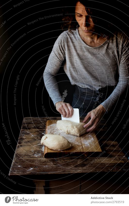 Person near cutting board with dough and flour on table Table Human being Dough Chopping board Flour loaf Wood Baked goods Set Meal Bakery Sweet Dessert Pie
