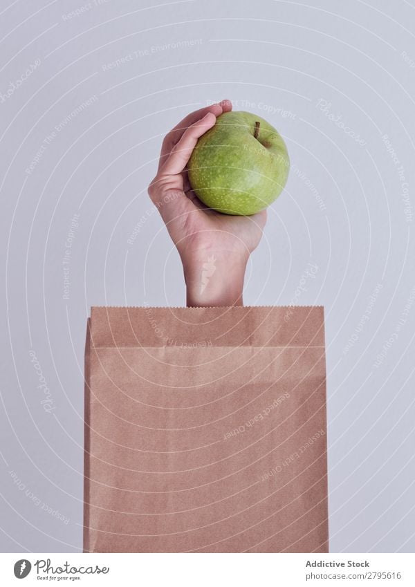 Person hand reached out from packet and holding apple Human being Hand Carrot Package Vegetable Food Bag Craft (trade) Paper Fresh Markets Healthy bunch haulm
