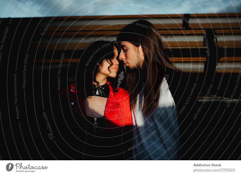 Long haired man and woman standing near train Couple abandoned wagons Embrace Railroad Graffiti old train Kissing Love Engines Hipster Youth (Young adults)