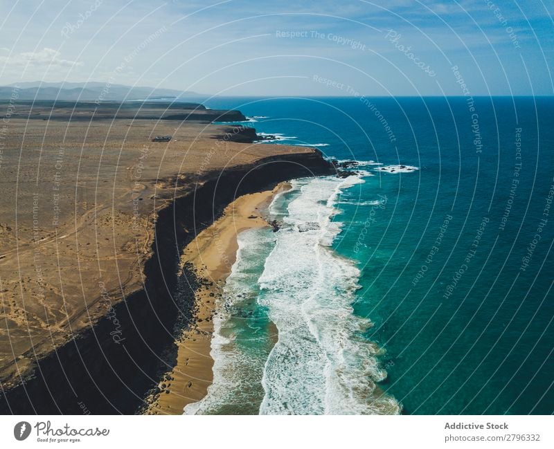 Amazing shoreline of ocean from drone Coast drone view Ocean Cliff Landscape Majestic Spain las palmas Fuerteventura Aircraft Nature Water Waves Power Turquoise