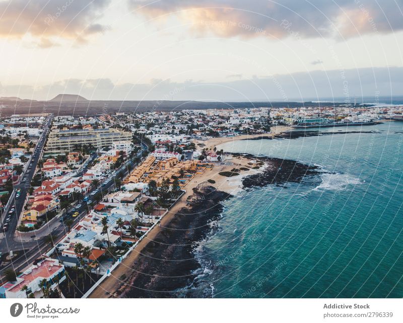 Scenic aerial view of city on ocean shore Coast City drone view Ocean Aircraft Fuerteventura las palmas Spain Picturesque Blue Sky Vacation & Travel