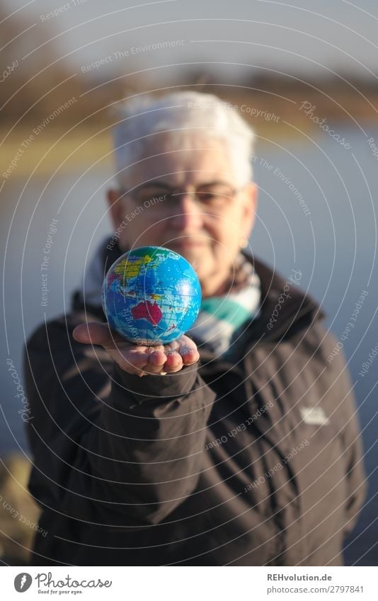 Senior holds a globe Earth Globe 60 years and older Grandmother Female senior Environmental pollution Environmental protection naturally Planet Climate change