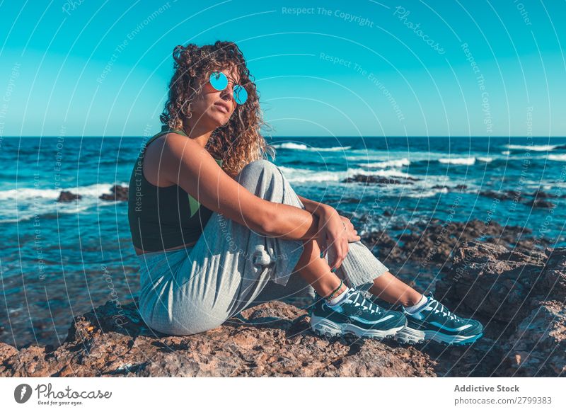 Stylish woman sitting near sea Woman Ocean Coast Dream Looking away embracing knees Sit Lifestyle Leisure and hobbies Rest Relaxation Waves Water Style