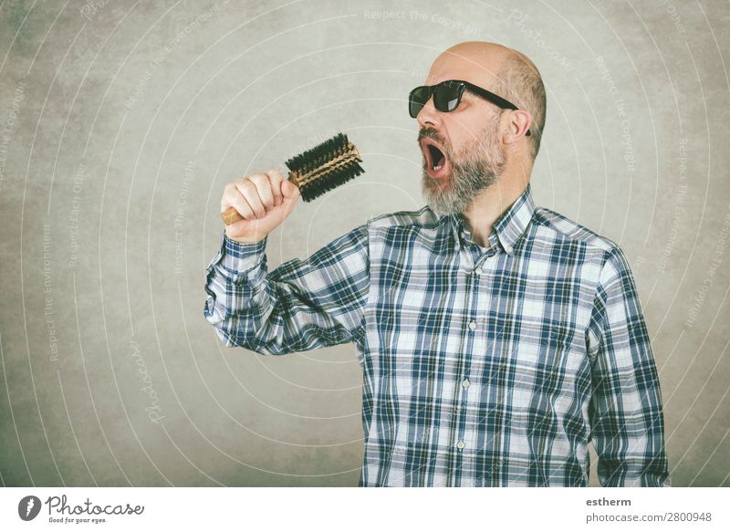 Man with sunglasses singing a hair brush against gray background Lifestyle Medical treatment Music Feasts & Celebrations Human being Masculine Adults Father 1