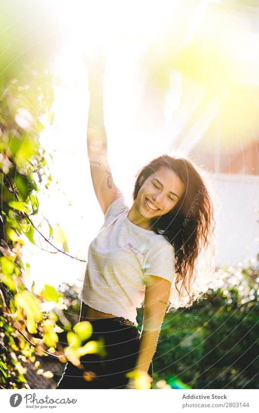 Cheerful woman in garden Woman Backyard Brunette Smiling Bushes Youth (Young adults) Sunbeam Day Gesture Garden Summer Style Easygoing Hip & trendy Park