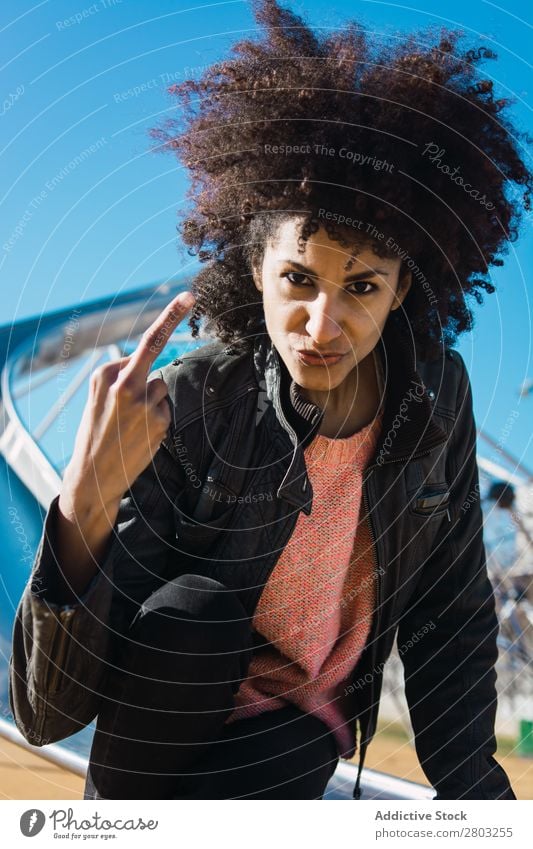 Woman with afro hair making insults. Adults Aggression Aggressive Anger attitude Bad Conceptual design Expression Fingers Gesture Girl Hand Human being Middle