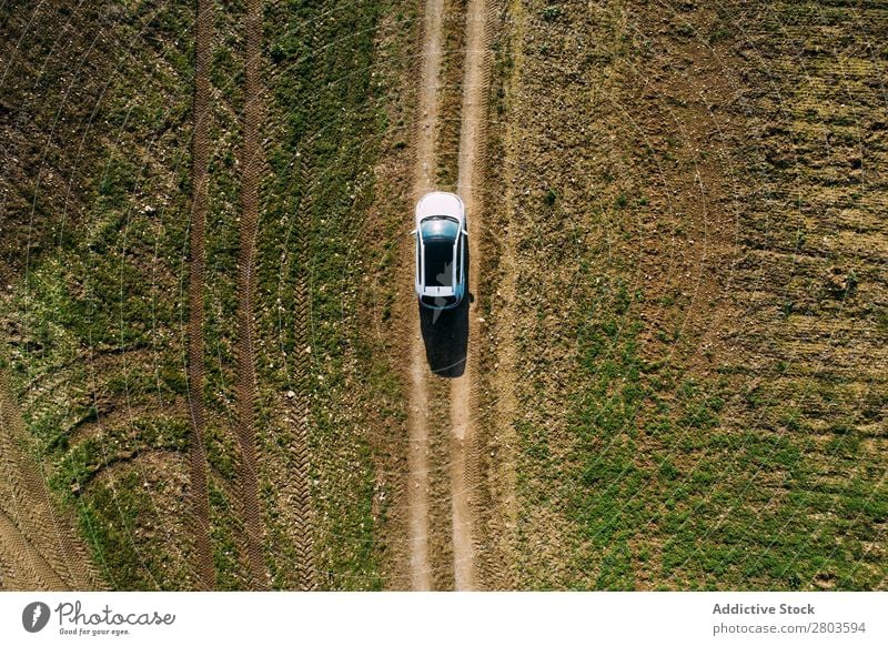 Aerial view of a car crossing a dirt road Vantage point Aircraft Street Car Landscape Vehicle Top Earth Drone Black Driving pov Countries Nature Field Transport