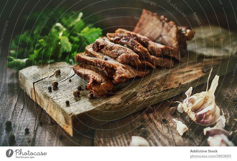 Spices near tasty fried meat Meat Ham Garlic Parsley Table Board Herbs and spices Food slices Dinner Frying Fresh Roasted Rustic Preparation Cooking Baking Meal