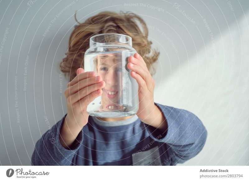 Boy holding vase with water near face Boy (child) Vase Water Smiling Clean Transparent Home Wall (building) White Face Easygoing Child Purity Clear Fresh