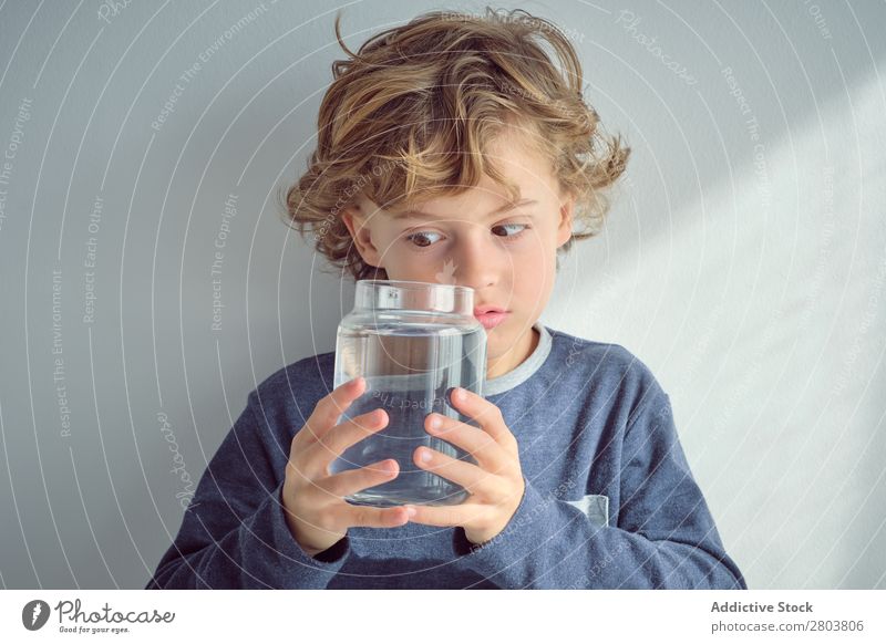 Boy holding vase with water near face Boy (child) Vase Water Clean Transparent Home Wall (building) White Face Easygoing Child Purity Clear Fresh Cheerful Joy