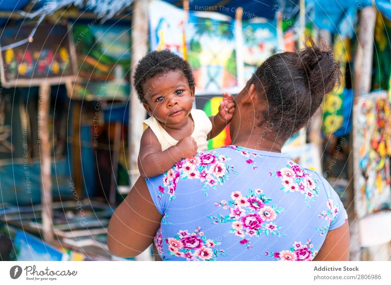 Black woman holding child near souvenir shop Mother Child Souvenir Shopping Jamaica African-American small shop Small Parents Tradition Tourism