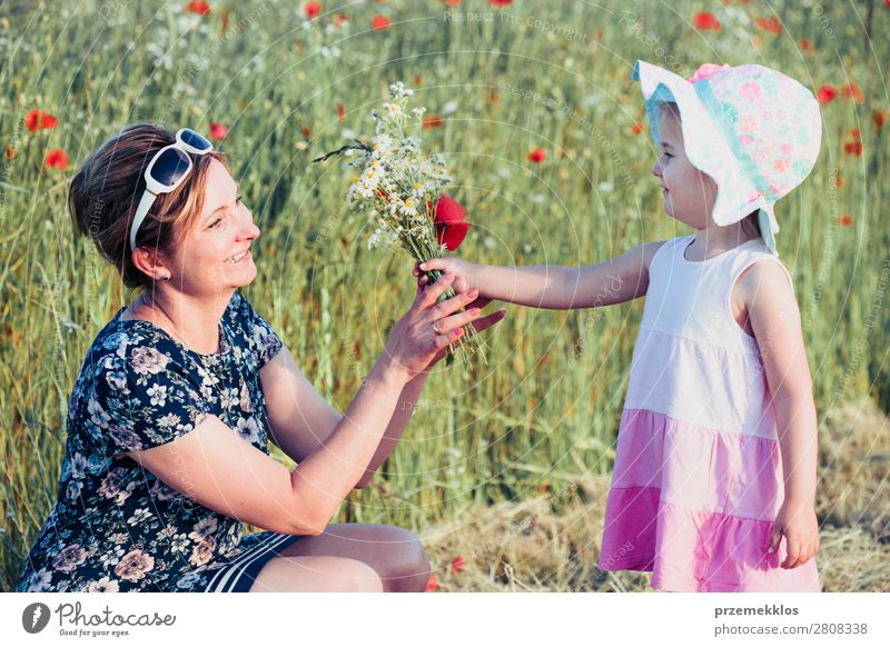 Mother and her little daughter in the field of wild flowers Lifestyle Joy Happy Beautiful Summer Garden Child Human being Woman Adults Parents