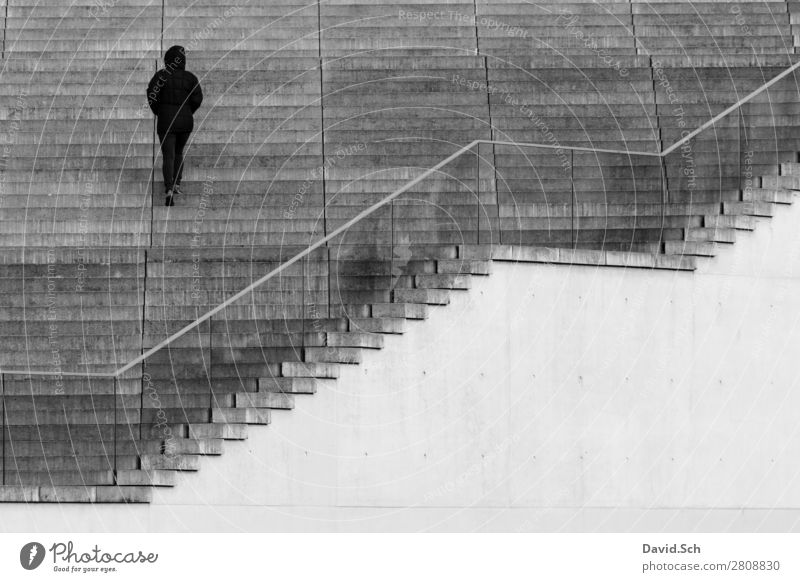 A person goes up a staircase Human being 1 Berlin Town Manmade structures Building Architecture Stairs Handrail Pedestrian Hooded (clothing) Jacket Stone