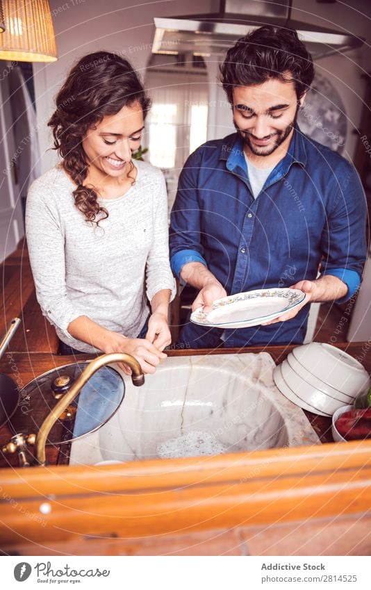 Young couple washing dishes in the kitchen Dish Wash Man Kitchen Housekeeping Woman Soap Guy Home Hot Clean Water Joy Partner aid Human being Relationship Girl