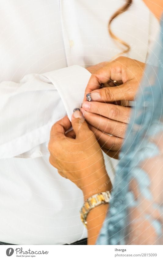 A groom putting on cuff-links in his wedding day. Elegant Style Wedding Office Business Human being Masculine Feminine Woman Adults Man Hand Fingers Fashion