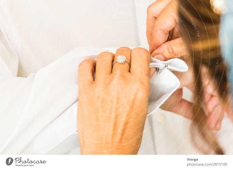 A groom putting on cuff-links in his wedding day Luxury Elegant Style Wedding Office Business Human being Masculine Woman Adults Man Hand 2 Fashion Clothing