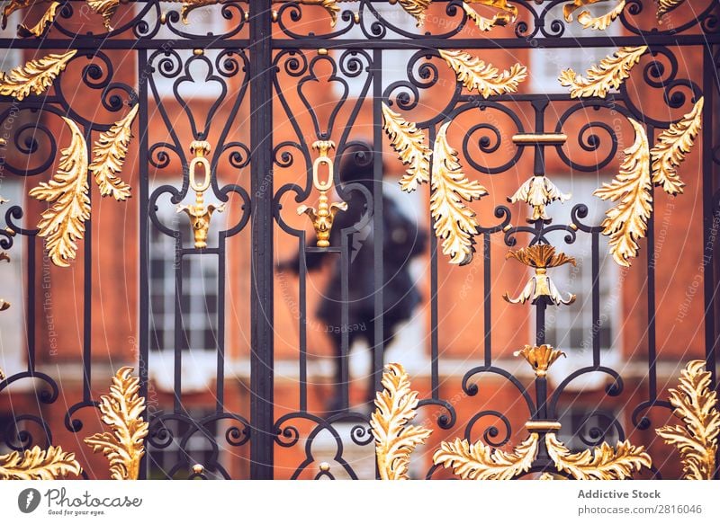 London, UK - October 13, 2016:Antique golden gates to Kensington Gate Gold Palace Royal England Historic Decoration Iron Art Monument Guard Entrance