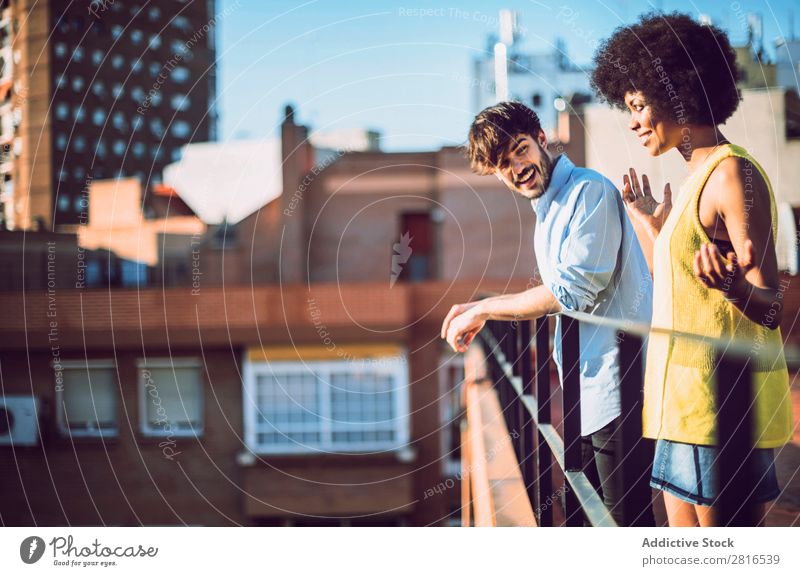 Interracial couple having fun on the rooftop Ethnic Youth (Young adults) Racing sports Caucasian Exterior shot Park African-American Boy (child) interracial