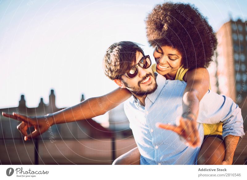 Interracial couple having fun on the rooftop Ethnic Youth (Young adults) Racing sports Caucasian Exterior shot Park African-American Boy (child) interracial