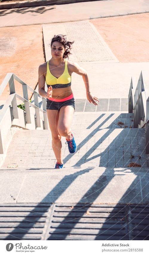 Athletic woman running up stairs during cardio - interval training Woman Fitness Running workout Speed Exterior shot Thin Heavy Determination Adults Human being