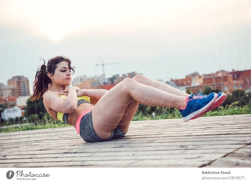 Young Woman working out outdoors and having fun Exterior shot Athletic Fitness Gymnasium Summer workout Park pushup Thin Determination Adults Strong Human being