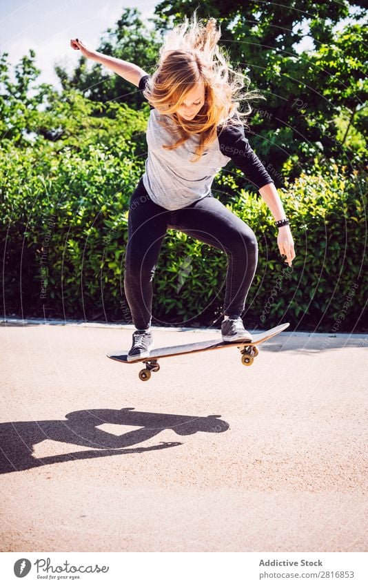 Skateboarder woman practicing ollie at park asian Action Exterior shot Sunlight Ramp Park Skateboarding committed determined Movement Human being 1 Woman Energy