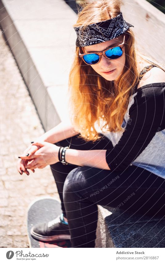 Woman skateboarder sitting in a park asian Skateboarding Sunglasses Joy Park Hat Chinese Music Town Culture Cap Exterior shot Sit Fitness 1 Black Hold Smiling