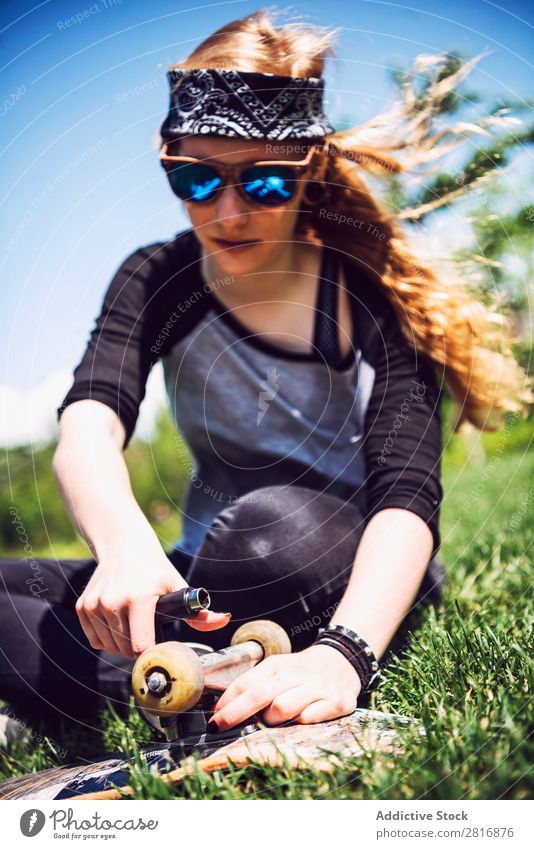 Young woman tightening nuts in trucks of her skateboard Screw Tighten Metal Reset Support Object photography Maintenance Stainless Mechanic Sunglasses Joy Park