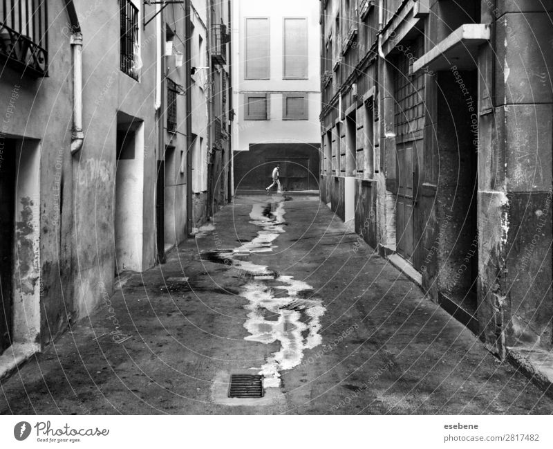 Walking on wet street Human being Masculine Man Adults Energy Discover Climate Target Street Street life Stairs Wet Black & white photo Exterior shot Morning