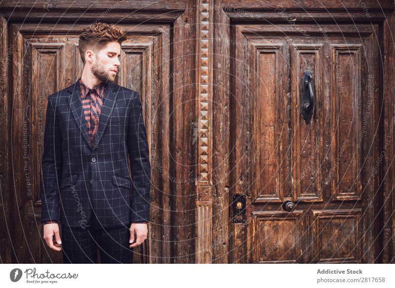 Handsome elegant young fashion man in trendy costume suit, old door wooden background Suit Man Gentleman Fashion fashionable Clothing Style Model Shirt