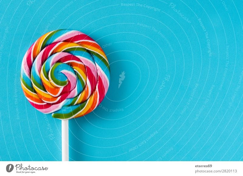 Colorful lollipop on blue background. Top view. Copyspace Lollipop Colour Multicoloured Sugar Candy Sweet Tasty Neutral Background Background picture Copy Space