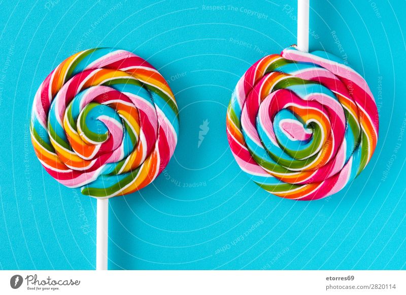 Colorful lollipops on blue background. Top view. Lollipop Colour Multicoloured Sugar Candy Sweet Tasty Neutral Background Background picture Copy Space Food